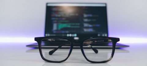 Geeky glasses sitting in front of a computer - the sign of a good content copywriter