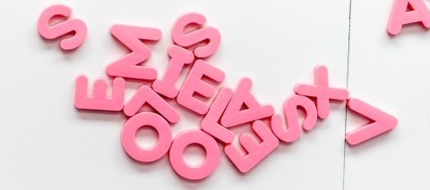 Disorganized English language letters - pink on a white background