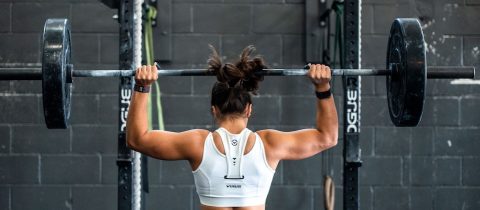 Powerful woman lifting heavy weight